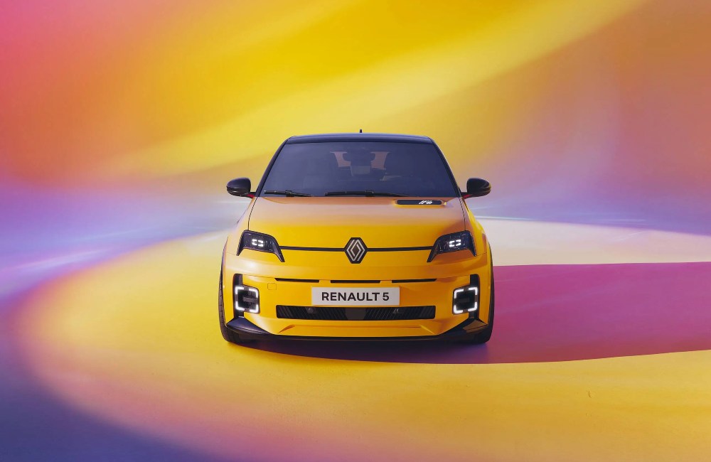 Front facing shot of a yellow new Renault 5 from a photoshoot.