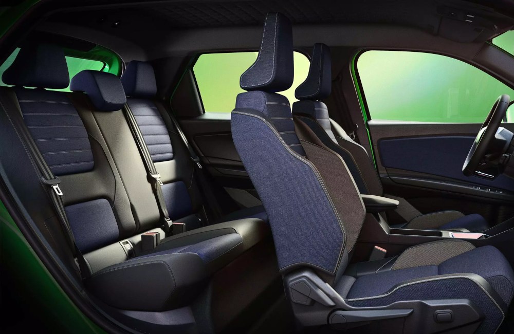 Wide shot of a Renault 5 interior, showing off the comfortable seating and interior blue colour choice.