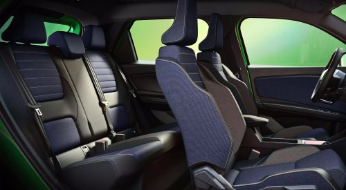 Wide shot of a Renault 5 interior, showing off the comfortable seating and interior blue colour choice.