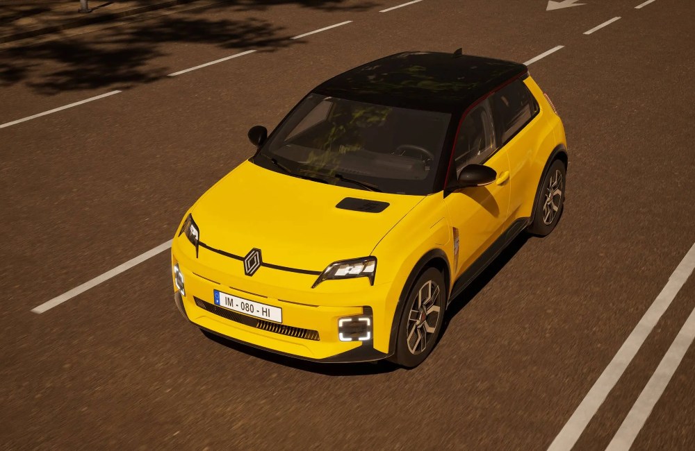 Angled top down shot of a yellow Renault 5 driving at speed down a city street.