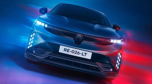 Front facing shot of a Renault Megane with turned on LED lighting and headlights, with a colourful background.