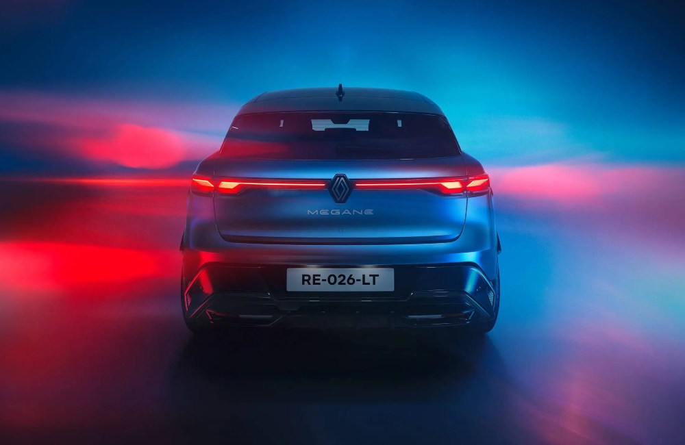 Rear shot of a Renault Megane E-Tech Electric with a red and blue colourful backdrop.