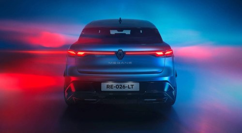 Rear shot of a Renault Megane E-Tech Electric with a red and blue colourful backdrop.