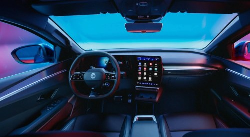 Interior shot of the driver cockpit of a Renault Megane E-Tech Electric, showing off the infotainment system and driving position.