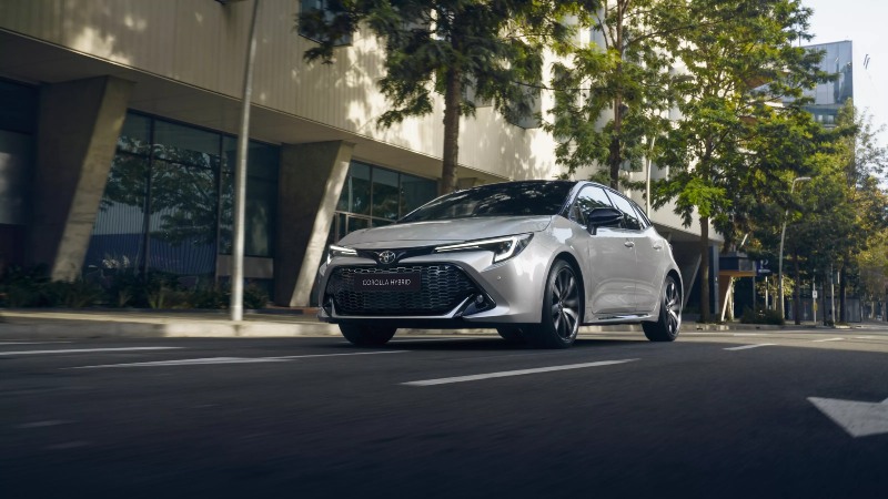 New Toyota corolla driving down street