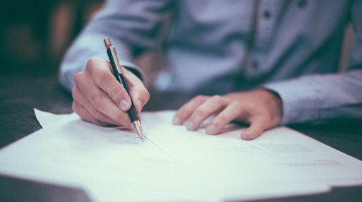 Man signing business contract van finance documents