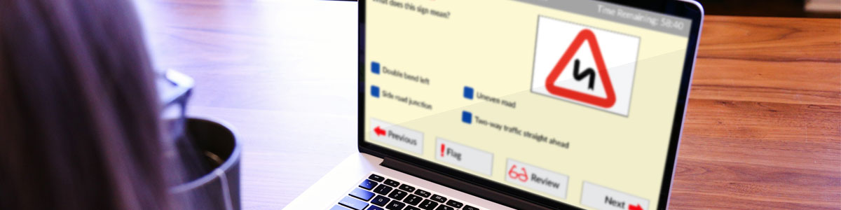 laptop showing a driving theory test multiple choice question laptop showing a driving theory test multiple choice question