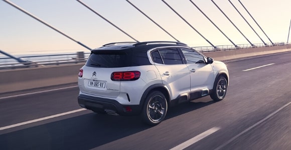 Silver Citroen on a lease driving on a bridge Silver Citroen on a lease driving on a bridge