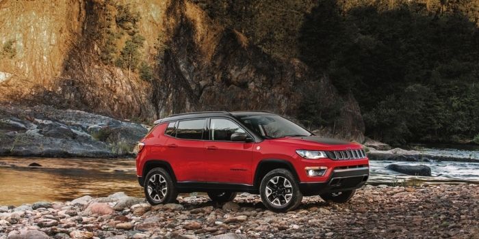 red jeep compass parked on riverside red jeep compass parked on riverside