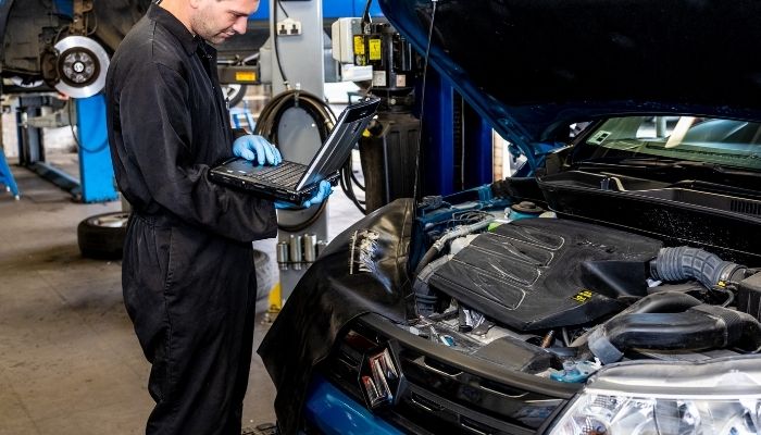 suzuki repairer inspecting a suzuki engine