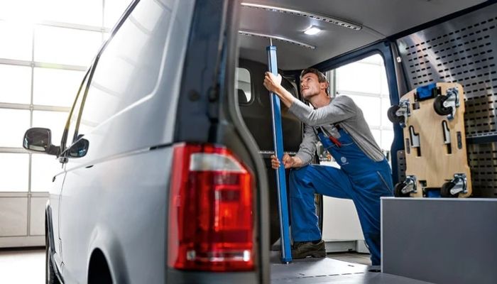 vw technician repairing the inside of a van