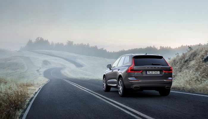 Used Volvo XC60 Driving Down a Winding Road