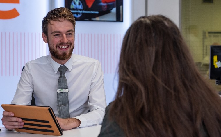 Stoneacre car dealership; sales person talking to a customer