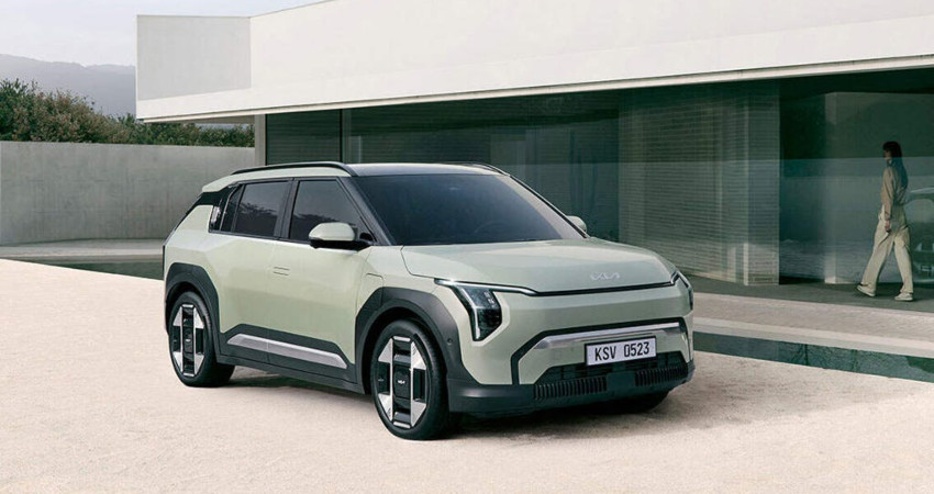 A green Kia EV 3 parked outside a contemporary home; How EVs work intro image