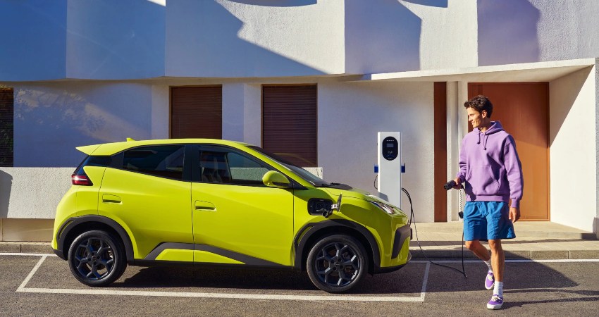 A man gets ready to charge a BYD Dolphin Surf on the street; How to charge an EV intro image