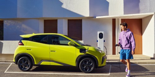 A man gets ready to charge a BYD Dolphin Surf on the street; How to charge an EV intro image