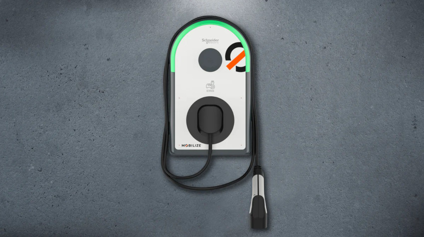 An EV wall charger hung on a concrete wall; Cost of home EV charging image