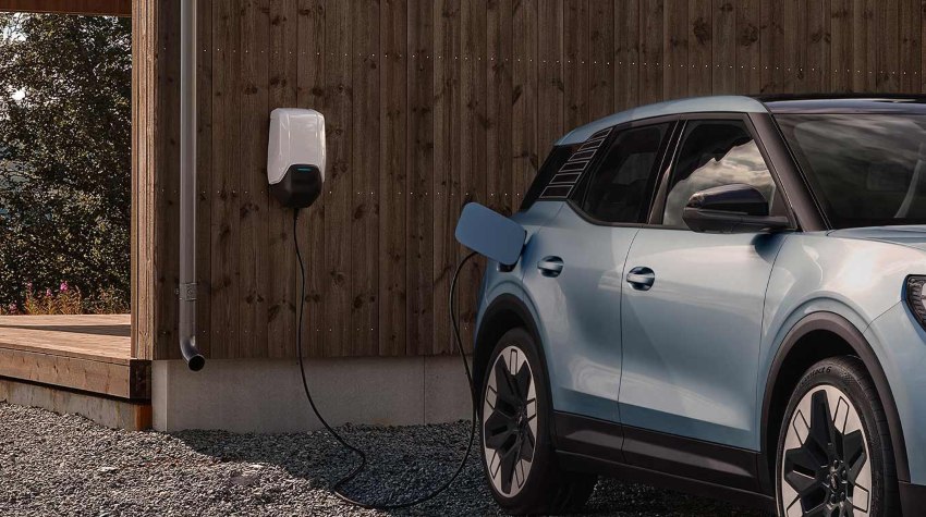 A blue Ford Explorer charges; EV home charger installation intro image