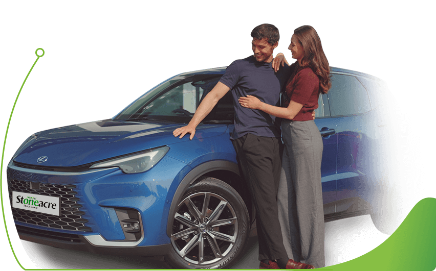 A couple stands in front of a Lexus LBX; Car finance options image.