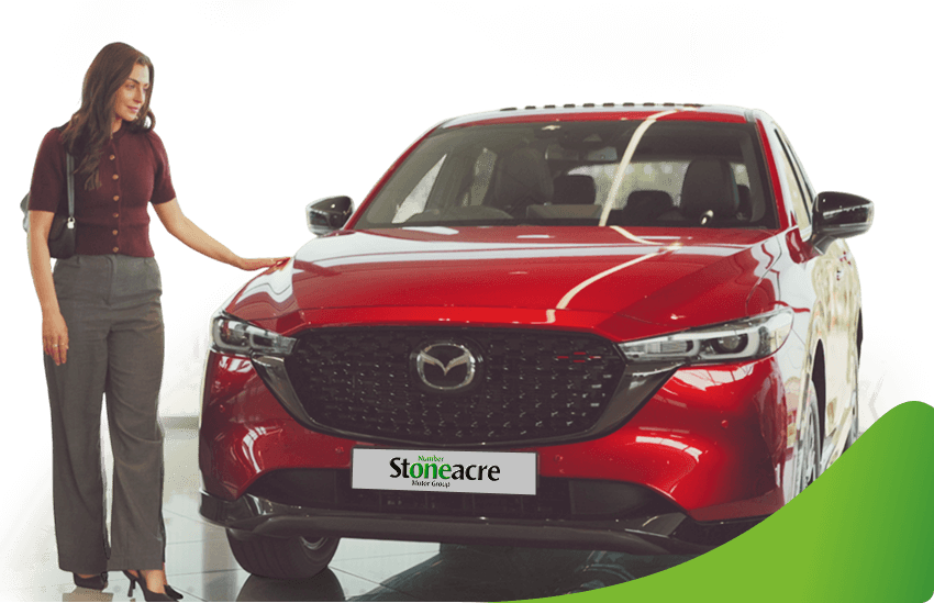 A woman stands beside a red Mazda CX-5; Car finance types image.