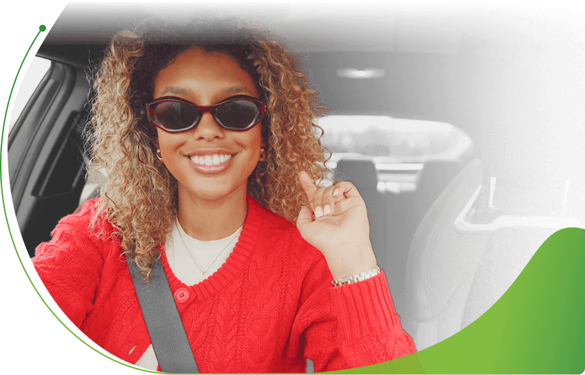 A woman with sunglasses on in the driver's seat of a car; How to get Car Finance on Benefits image