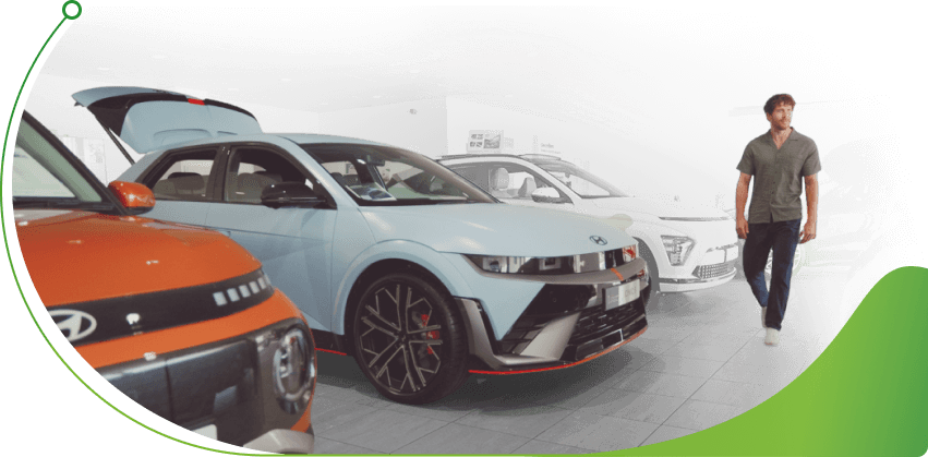 Man walks through a Hyundai showroom; Car finance broker vs Lender image