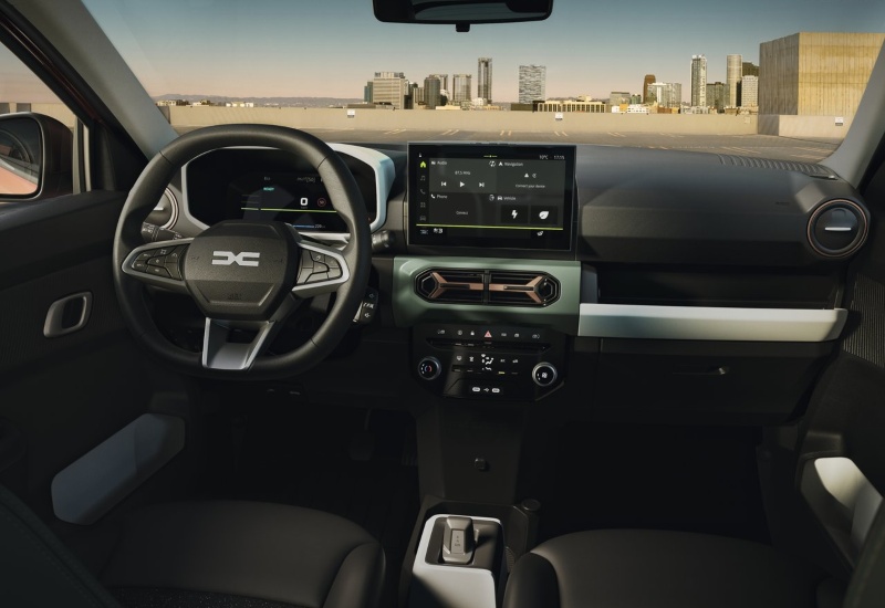 The interior of a used Dacia Spring, showing the dashboard, steering wheel, and centre console.