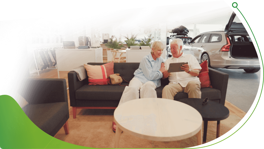 An older couple sit on a sofa in a car showroom; How does hire purchase car finance work image