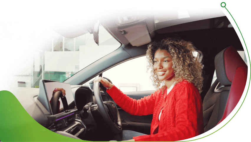 A woman sits in the driver's seat of a car; Pay as you go Car Finance for Bad Credit image