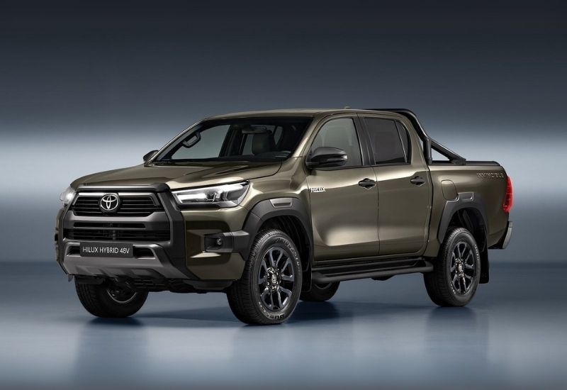 The new Toyota Hilux Hybrid 48V pickup in bronze, showcasing a bold front design and stylish black alloy wheels.