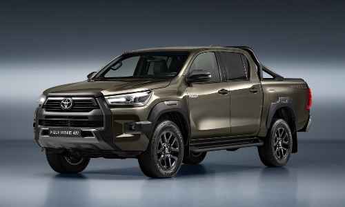 The new Toyota Hilux Hybrid 48V pickup in bronze, showcasing a bold front design and stylish black alloy wheels.