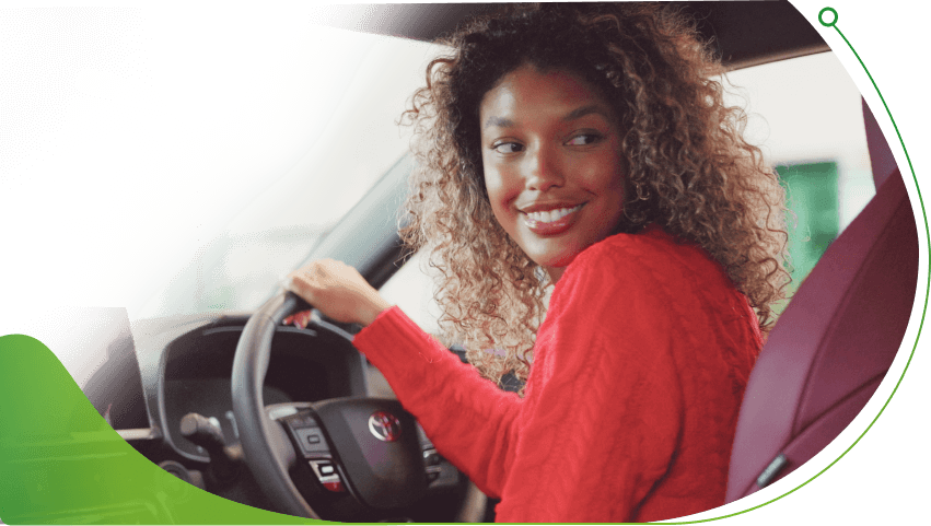 A woman looks around a Toyota interior; Law on Guaranteed Car Finance UK image