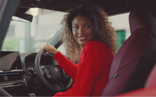 A woman looks around a Toyota interior; Law on Guaranteed Car Finance UK image