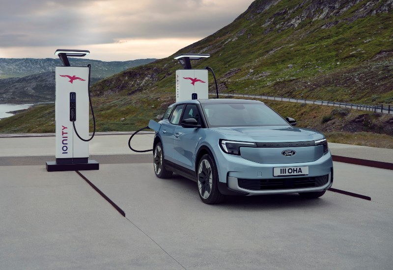 Used Ford Explorer for sale in Arctic Blue, plugged into a fast charging point.