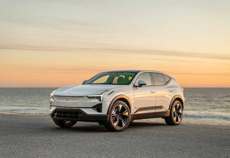 Used Polestar 3 SUV Used Polestar 3 SUV parked by the ocean at sunset.