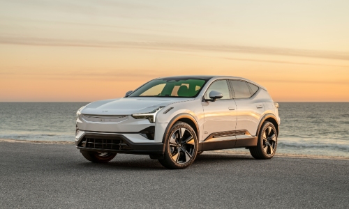 Used Polestar 3 SUV Used Polestar 3 SUV parked by the ocean at sunset.
