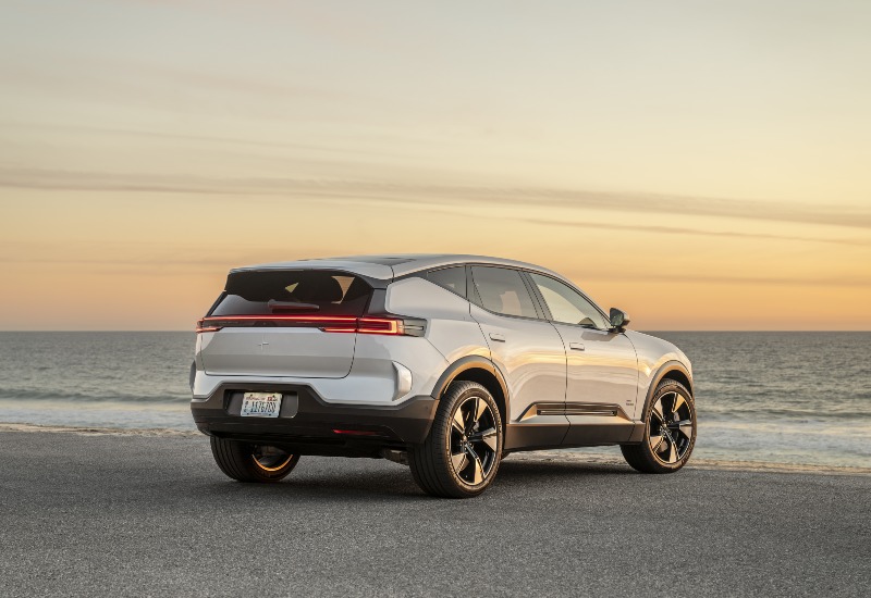 Rear view of a used Polestar 3 premium SUV near the beach.
