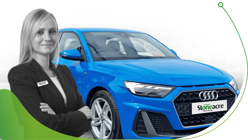 A sales person stands in front of a blue Audi; Car Finance for First-Time Drivers image