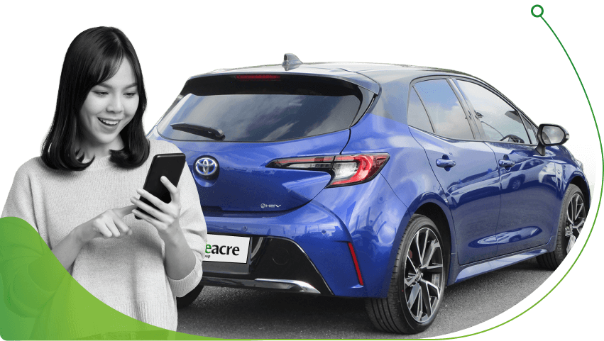 A woman on a phone in front of a blue Toyota Corolla; Credit History image