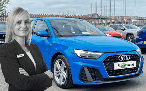 A sales person stands in front of a blue Audi; Car Finance for First-Time Drivers image