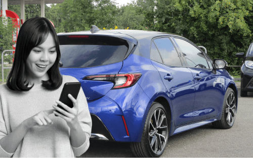 A woman on a phone in front of a blue Toyota Corolla; Credit History image