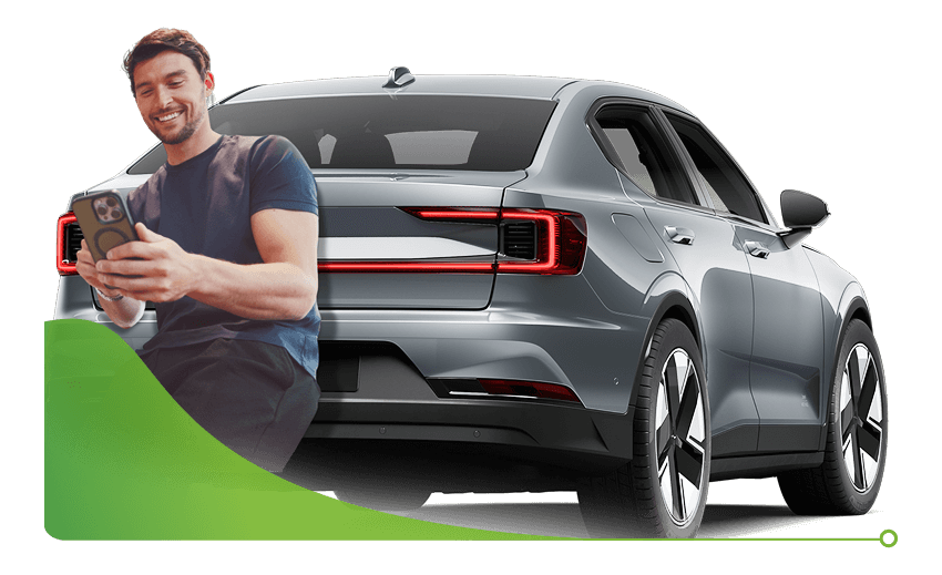 Man looks at phone happily in a car dealership; Bad credit car finance dealership image.