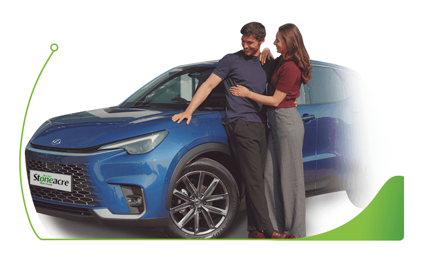 A couple stands in front of a Lexus LBX; Car finance options image.