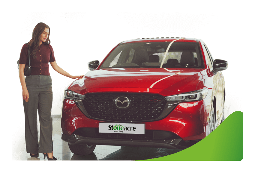 A woman stands beside a red Mazda CX-5; Car finance types image.