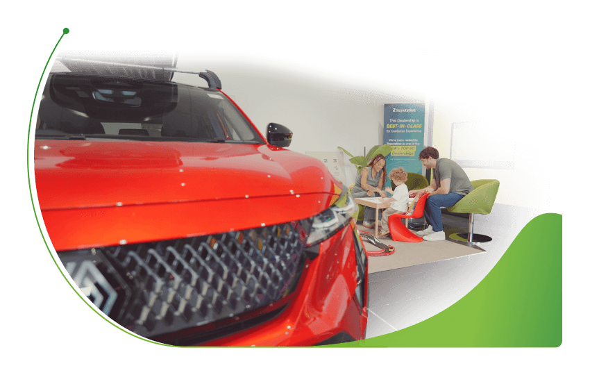 A family in a car dealer's play area besides a red Renault; 0% used cars finance image