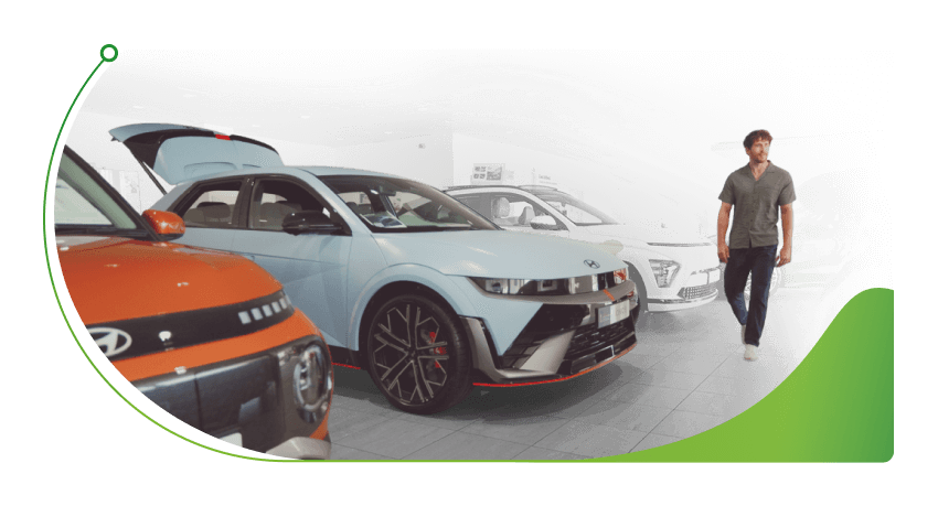Man walks through a Hyundai showroom; Car finance broker vs Lender image