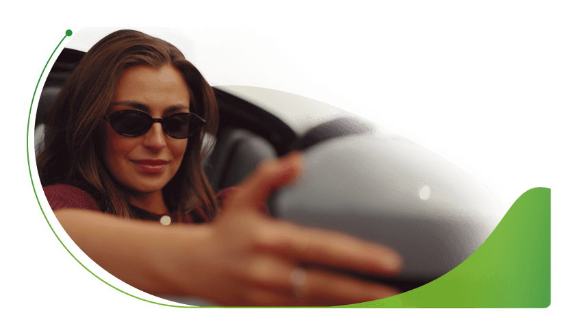 A woman in a car adjusts the wing mirror; What is personal contract purchase car finance image