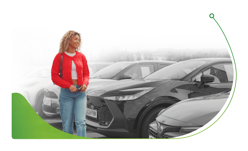 A woman walks past cars; How to Get Car Finance as a Student image