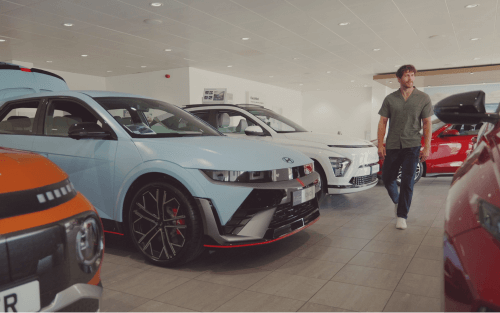 A man walks through a Hyundai showroom; Pros & Cons to the balloon payment image