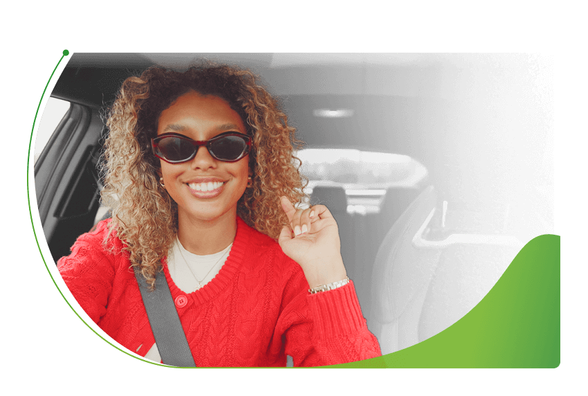 A woman sits in a car; Bought a car with outstanding finance image